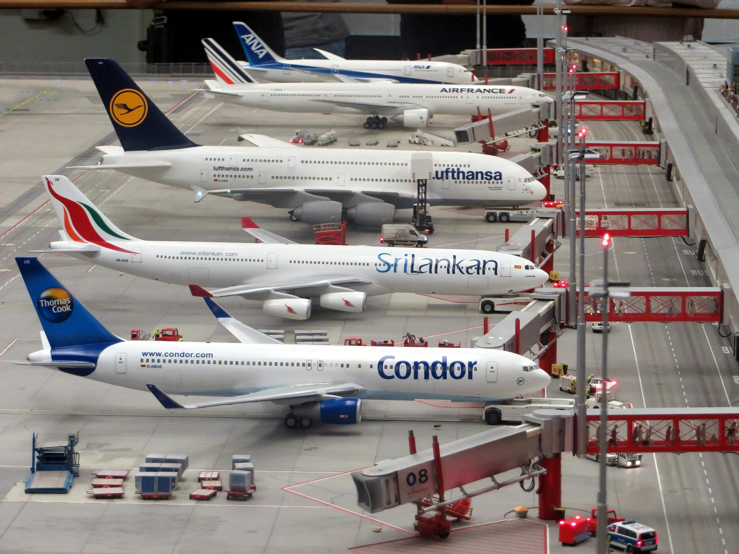Detailed miniature model of an airport terminal with various aircraft brands on display.